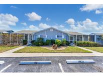 Charming building exterior with well-maintained landscaping and parking at 3300 Loveland Blvd # 1504, Punta Gorda, FL 33980