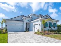 Beautiful single Gathering home featuring a paver driveway and 3-car garage at 11571 Gleaming Ter, Venice, FL 34293