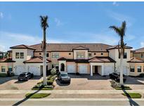 Spacious condos with terracotta tile roofs and paved driveways, perfect for relaxed community living with tropical landscaping at 23108 Banbury Way # 202, Venice, FL 34293