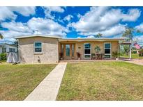 Charming single-story home with a well-maintained lawn and inviting front porch at 6627 Marius Rd, North Port, FL 34287