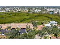Beautiful aerial view of a condo community surrounded by lush greenery and waterways at 1106 Bird Bay Way # 316, Venice, FL 34285
