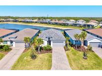 Stunning aerial view of home with lake view and lush landscaping at 14724 Ponce De Leon Trl, Port Charlotte, FL 33981