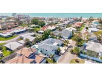 Stunning aerial view of beach house with pool and outdoor seating in a desirable coastal neighborhood at 605 Cornwell On The Gulf, Venice, FL 34285