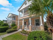 This charming home boasts double porches, a well-kept lawn, and mature palm trees at 12468 Shimmering Oak Cir, Venice, FL 34293
