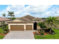 Charming single-Gathering home with a two-car garage, well manicured landscaping, and a tile roof at 13238 Famiglia Dr, Venice, FL 34293