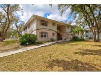 Charming two-story condo featuring neutral siding, shutters and a well-maintained lawn at 1051 Forrest Nelson Blvd # A-103, Port Charlotte, FL 33952