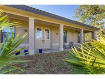 Inviting front porch with stylish columns and double doors welcomes you home at 1115 Gladstone Blvd, Englewood, FL 34223