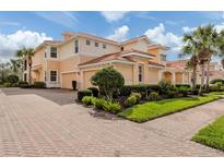 Beautiful Mediterranean-style home with a brick driveway and lush landscaping at 142 Bella Vista Ter # A, North Venice, FL 34275
