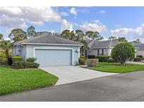 Charming one-story home with a two-car garage, well-manicured lawn, and beautiful landscaping at 1610 Monarch Dr # 1610, Venice, FL 34293