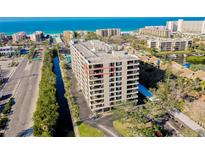 Beautiful aerial view of high-rise condo building with beach and ocean views at 6415 Midnight Pass Rd # 909, Sarasota, FL 34242
