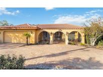 Beautiful Mediterranean-style home with a spacious brick driveway and a terra cotta tile roof at 6427 Canary St, Sarasota, FL 34241