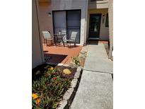 Cozy front patio with table set and beautiful landscaping leading to the front door of the home at 726 Bird Bay Cir # 46, Venice, FL 34285