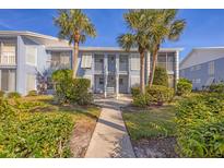 A beautiful two-story condo with a charming walkway and mature tropical landscaping at 454 Cerromar Rd # 174, Venice, FL 34293