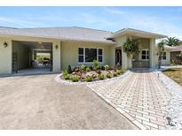 Charming single-story home featuring an attached carport, and attractive landscaping at 771 Stewart St, Englewood, FL 34223