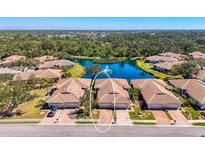 Stunning aerial view of homes with lake, fountain, and lush landscaping at 1022 Yosemite Dr, Englewood, FL 34223
