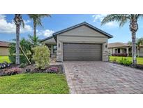 Charming single-Gathering home with a paved driveway and tropical landscaping at 19180 Mangieri St, Venice, FL 34293