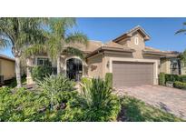 Charming single-story home with lush landscaping and a well-maintained paver driveway, creating inviting curb appeal at 19651 Quisto St, Venice, FL 34293
