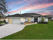 Charming single-story home with well-manicured lawn and two-car garage at 2114 S Biscayne Dr, North Port, FL 34287