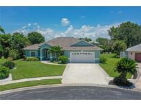 Charming home boasts lush landscaping, a well-manicured lawn, and a welcoming two-car garage at 213 Bayside Ct, Nokomis, FL 34275