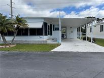 Charming single-story home with carport and manicured lawn at 218 Palm Air Dr, Osprey, FL 34229