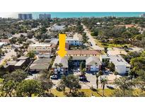 An aerial view of the condo community, nestled in lush greenery near the ocean, offering a tranquil coastal living experience at 236 Harbor S Dr # 202, Venice, FL 34285