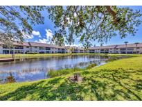 Scenic lake view surrounded by lush landscaping in this condo community, offering tranquility and natural beauty at 275 Mission W Trl # G, Venice, FL 34285