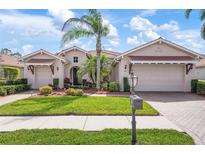Stunning single-Gathering home with a meticulously maintained lawn, mature landscaping, and a private two-car garage at 297 Martellago Dr, North Venice, FL 34275