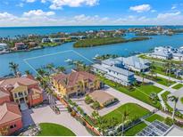Stunning aerial view of waterfront property with private dock, lush landscaping, and gorgeous ocean views at 471 Bayshore Rd, Nokomis, FL 34275