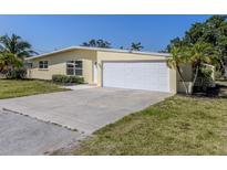 Charming single-story home featuring an attached two-car garage and a well-maintained front yard at 501 Dona Dr, Nokomis, FL 34275
