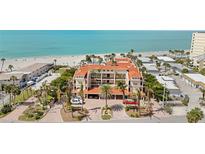 Stunning aerial view of the Ocean Sands condo complex nestled along a beautiful beach with pristine turquoise waters at 718 Golden Beach Blvd # 2, Venice, FL 34285