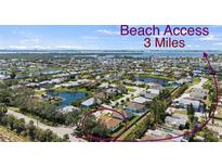 Beautiful aerial view of a residential community with waterfront homes and easy access to the beach, just 3 miles away at 8603 46Th Avenue W Cir, Bradenton, FL 34210