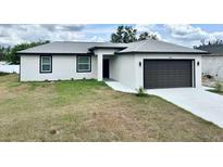 New construction single-story home featuring a two-car garage and modern design at 12316 Durango Ave, North Port, FL 34287