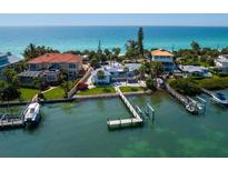 Stunning waterfront homes with private docks and beach access boast incredible views of the turquoise ocean waters at 1604 Casey Key Rd, Nokomis, FL 34275