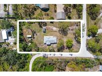 An aerial view of a property showcasing the home, surrounding landscape, and lot size at 1871 Bridge St, Englewood, FL 34223