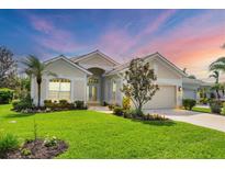 Beautiful single-story home with lush landscaping, a tile roof, and a well-manicured lawn at 339 Marsh Creek Rd, Venice, FL 34292