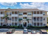 Condo building featuring multiple units with screened patios, well-maintained landscaping, and convenient parking at 4802 51St W St # 1816, Bradenton, FL 34210