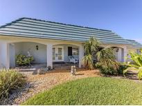 Charming home featuring a light blue tile roof and a well-manicured lawn at 601 Apalachicola Rd, Venice, FL 34285