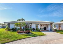 Charming single-story home featuring well-maintained landscaping, tile roof and an inviting front entrance at 72 Circlewood Dr # A2-7, Venice, FL 34293