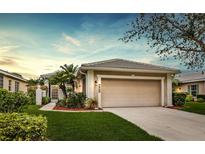 Charming single-story home with lush landscaping and a neutral color palette at 902 Tartan Dr # 29, Venice, FL 34293