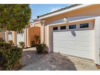Attached one car garage with a concrete driveway and manicured landscaping at 903 Gondola Park Dr # 903, Venice, FL 34292
