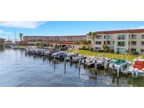 Beautiful waterfront condo with boat slips, manicured green spaces, and a picturesque building with a red tile roof at 1 Colony Point Dr # 11A, Punta Gorda, FL 33950