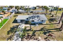 Aerial view of home featuring a well-manicured lawn, and driveway at 1075 Falcon Rd, Venice, FL 34293