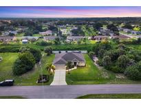 Beautiful aerial view of a well-maintained single-Gathering home with lush landscaping and a long driveway at 2694 Hopwood Rd, North Port, FL 34287