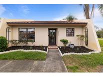 Charming single-story home with well-maintained landscaping and inviting walkway leading to the front door at 3641 Longmeadow # 33, Sarasota, FL 34235