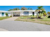 Charming single-story home with a carport, manicured lawn, and inviting curb appeal at 521 Circlewood Dr # Q11, Venice, FL 34293