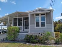 Charming single-story home featuring a screened-in porch and well-maintained landscaping at 601 Club House Rd, Venice, FL 34285