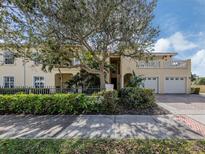 Charming two-story home featuring a two-car garage, balcony, and mature landscaping at 632 Golf Dr # 632, Venice, FL 34285