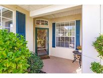 Welcoming front porch with blue shutters and charming decor offers a delightful entrance at 921 Tartan Dr # 31, Venice, FL 34293