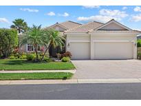 Charming home with well-maintained landscaping, two-car garage, and inviting curb appeal at 12127 Granite Woods Loop, Venice, FL 34292