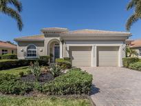 Charming single-story home with a well-manicured lawn and a three-car garage at 125 Savona, North Venice, FL 34275